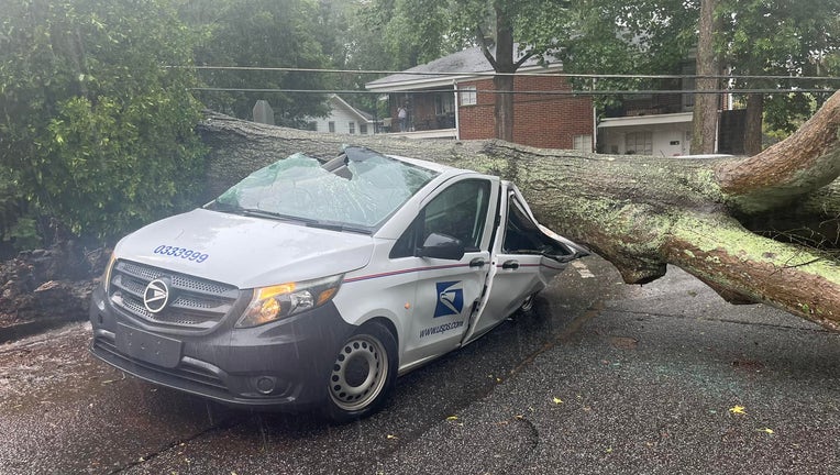 Tree falls on USPS truck in Athens